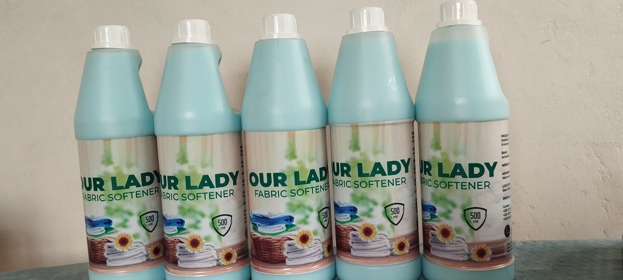 Tropical-themed display of four natural cleaning products, featuring ginger and coconut ingredients, with palm leaves in the background.