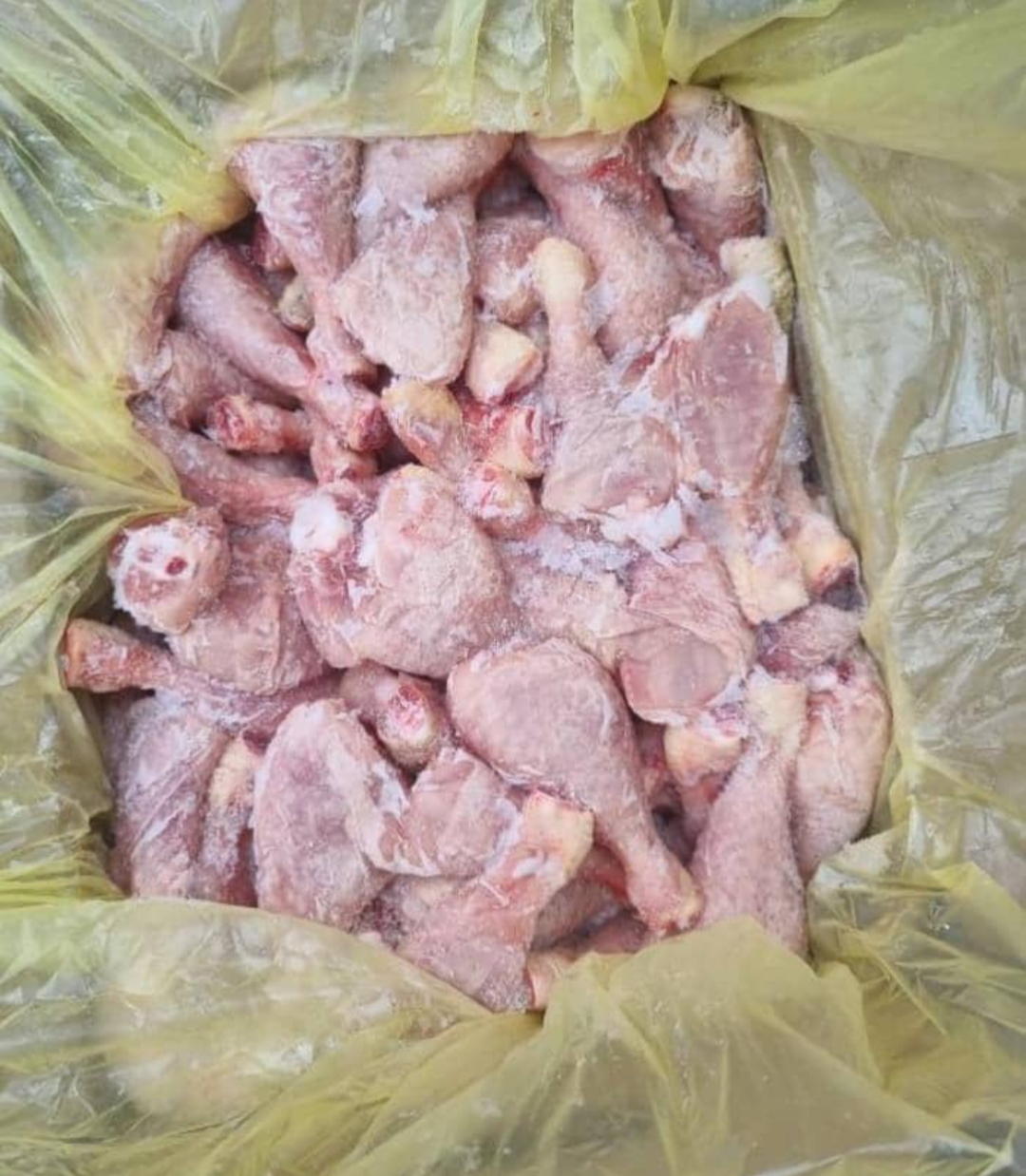 Interior of a modern warehouse with shelves stocked with boxes, jars, and food products.