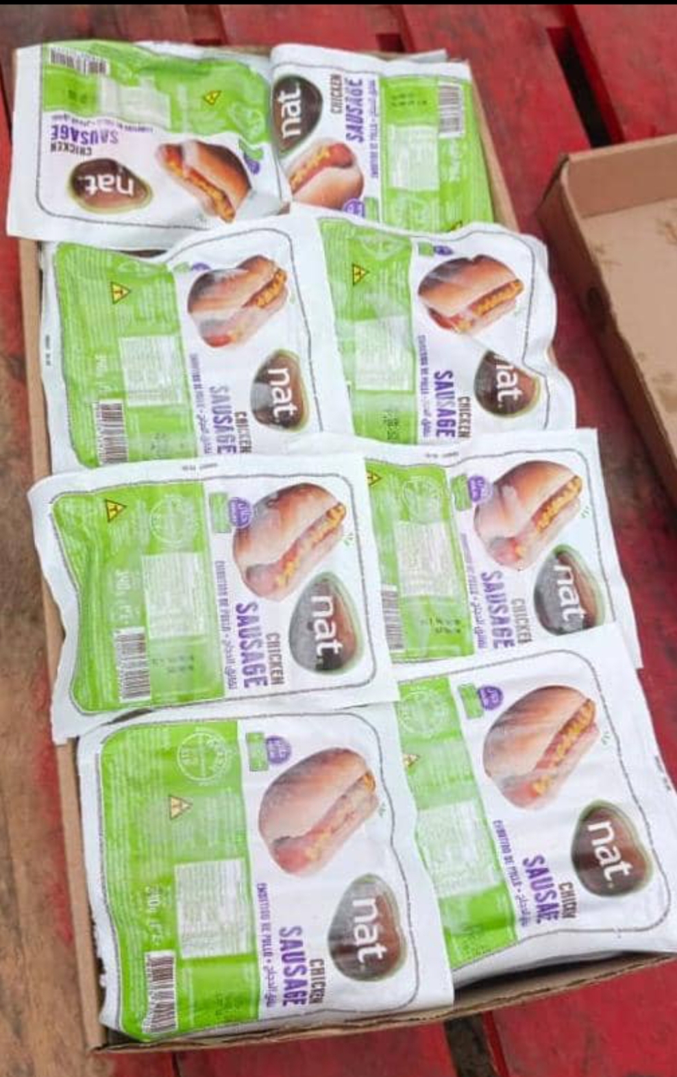 Sliced roast beef with garnish on a wooden cutting board, surrounded by cherry tomatoes and parsley.