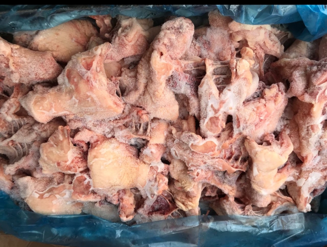 Fresh fruits and vegetables including apples, avocados, broccoli, lemons, and red bell peppers arranged on a light blue background.