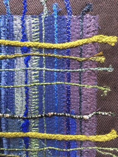 Fils tissés tons mauves et vert anis
