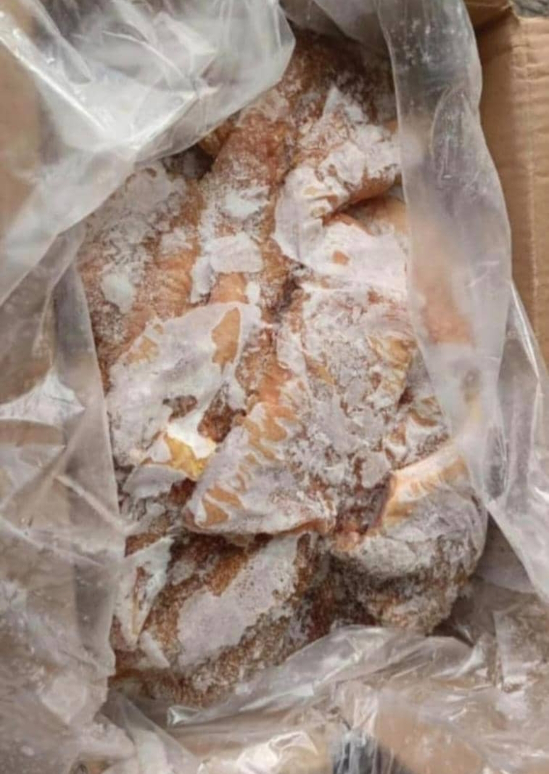 Fresh salmon fillets garnished with herbs on a wooden board, surrounded by sliced lemon, grapes, cherry tomatoes, and dishes of sauce and seasoning.