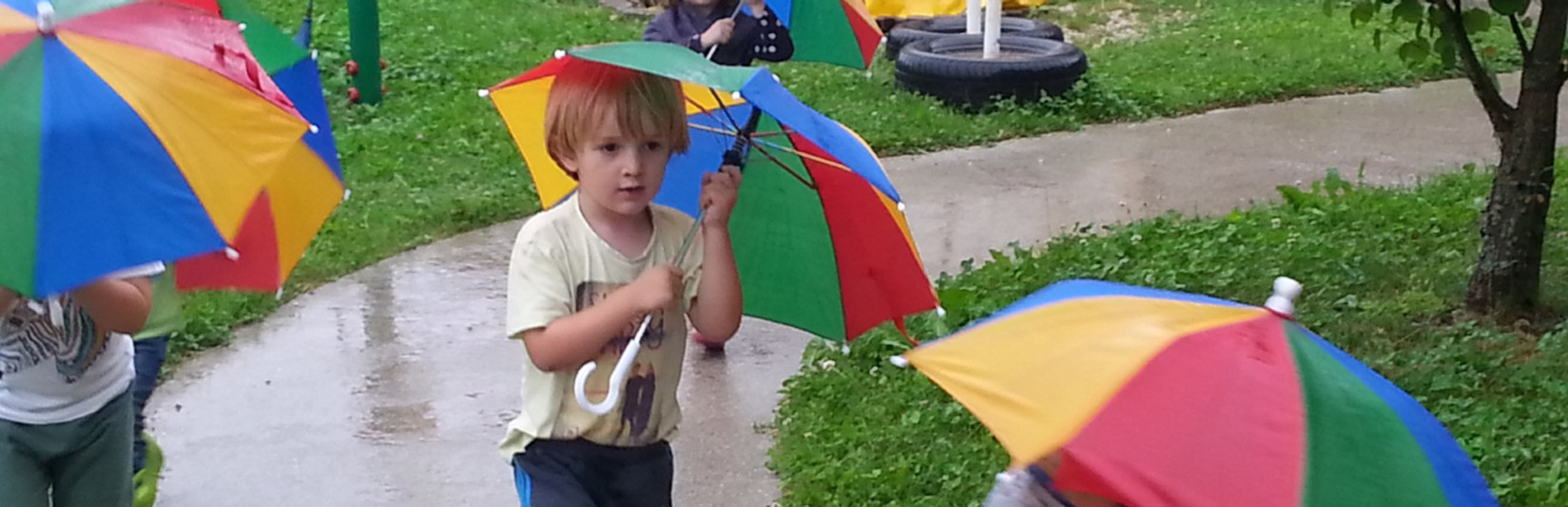 <div class="naslov"> <h1>Who is afraid of raindrops?
</h1> <p class="p-slid">We are not! Singing and dancing with our colorful umbrellas. </p> </div>