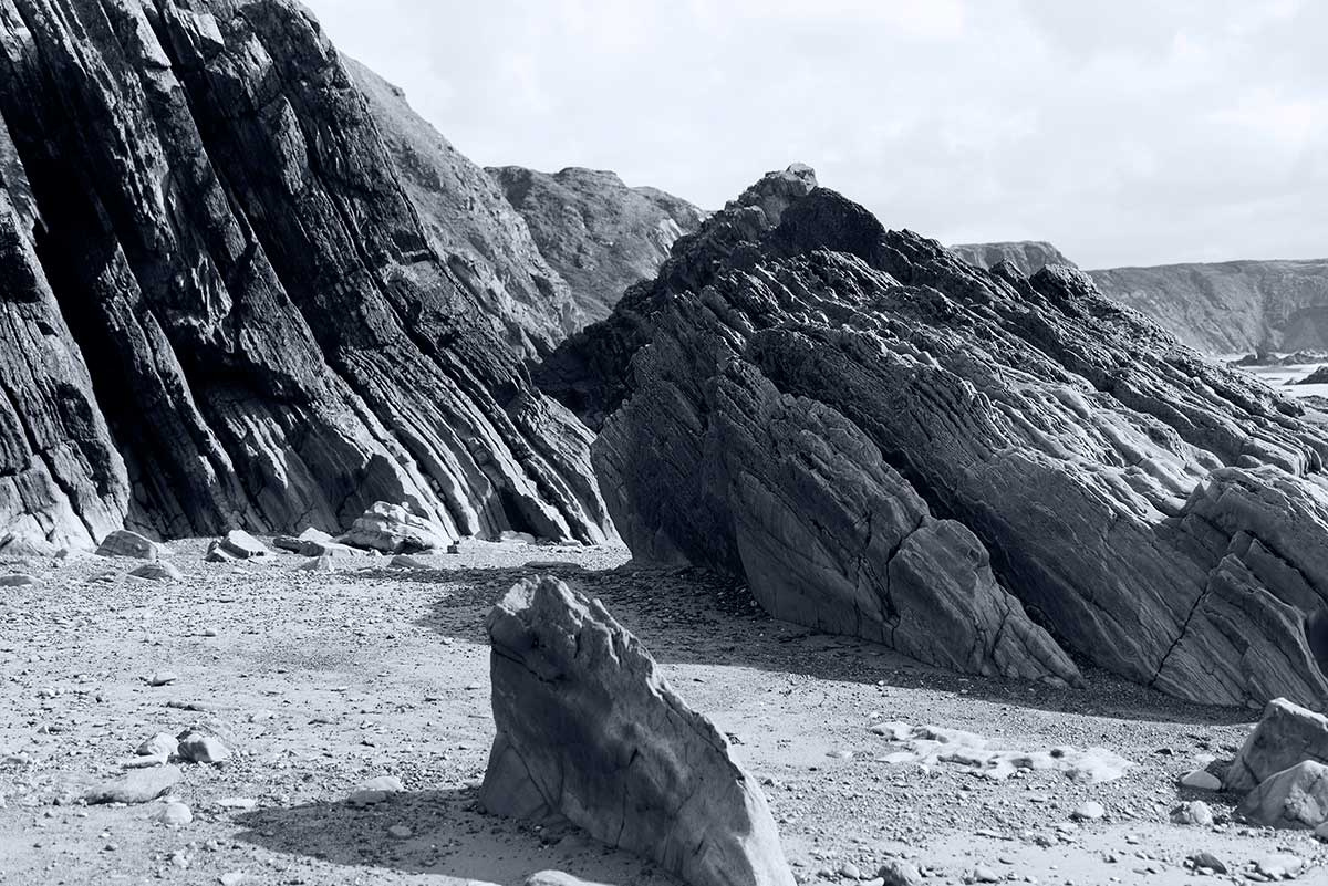 rock strata on Marloes Sands Beach Pembrokeshire black and white photograph by Mark Lloyd Williams