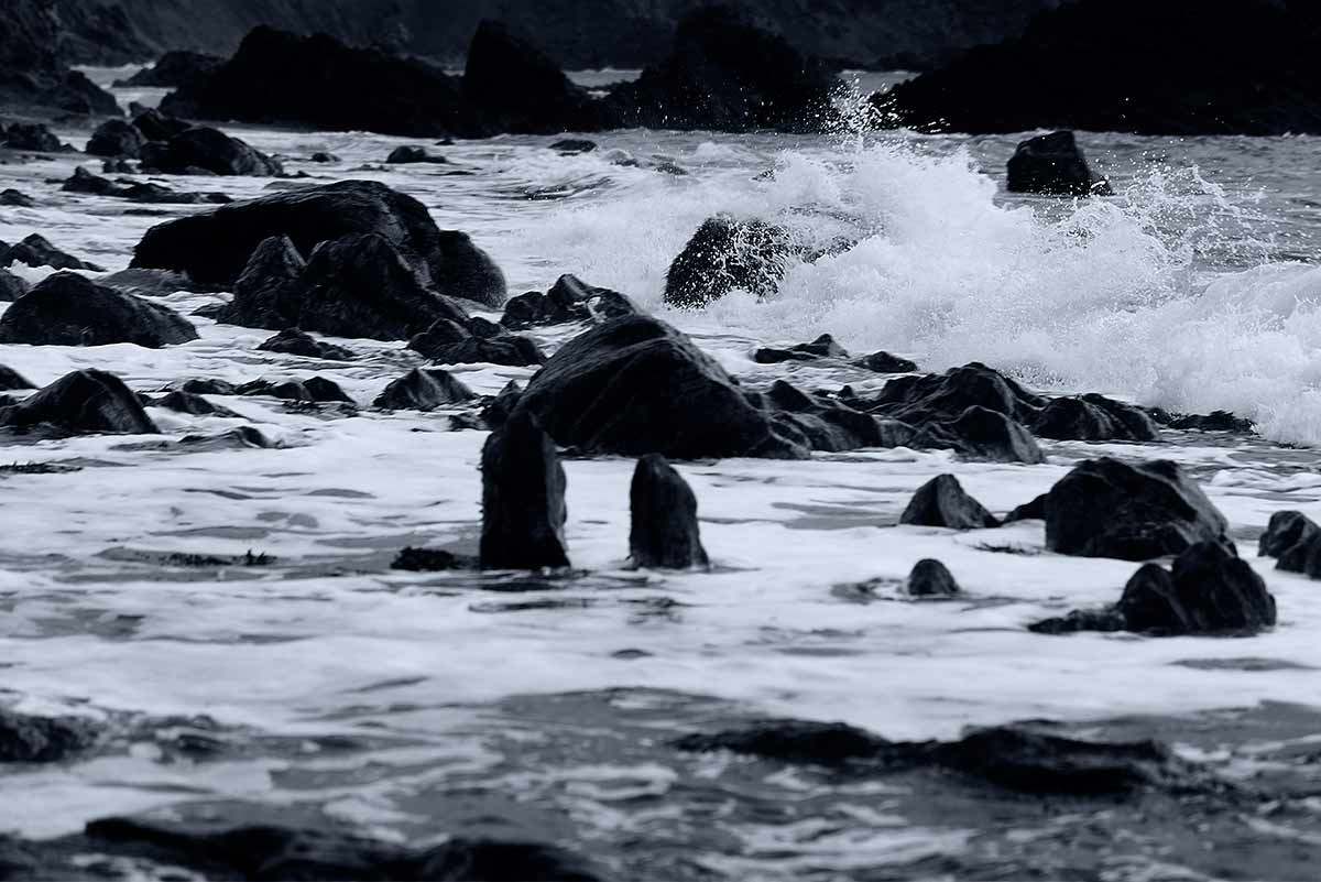black and white photograph print of waves breaking on rocks at Marloes Sands Pembrokeshire