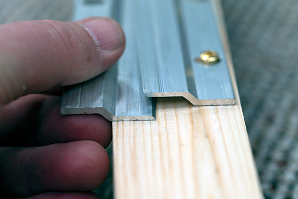 WE USE THESE ALMINIUM SAFETY HANGING PLATES FOR LARGE FRAMES: SIMPLE BUT VERY SECURE.