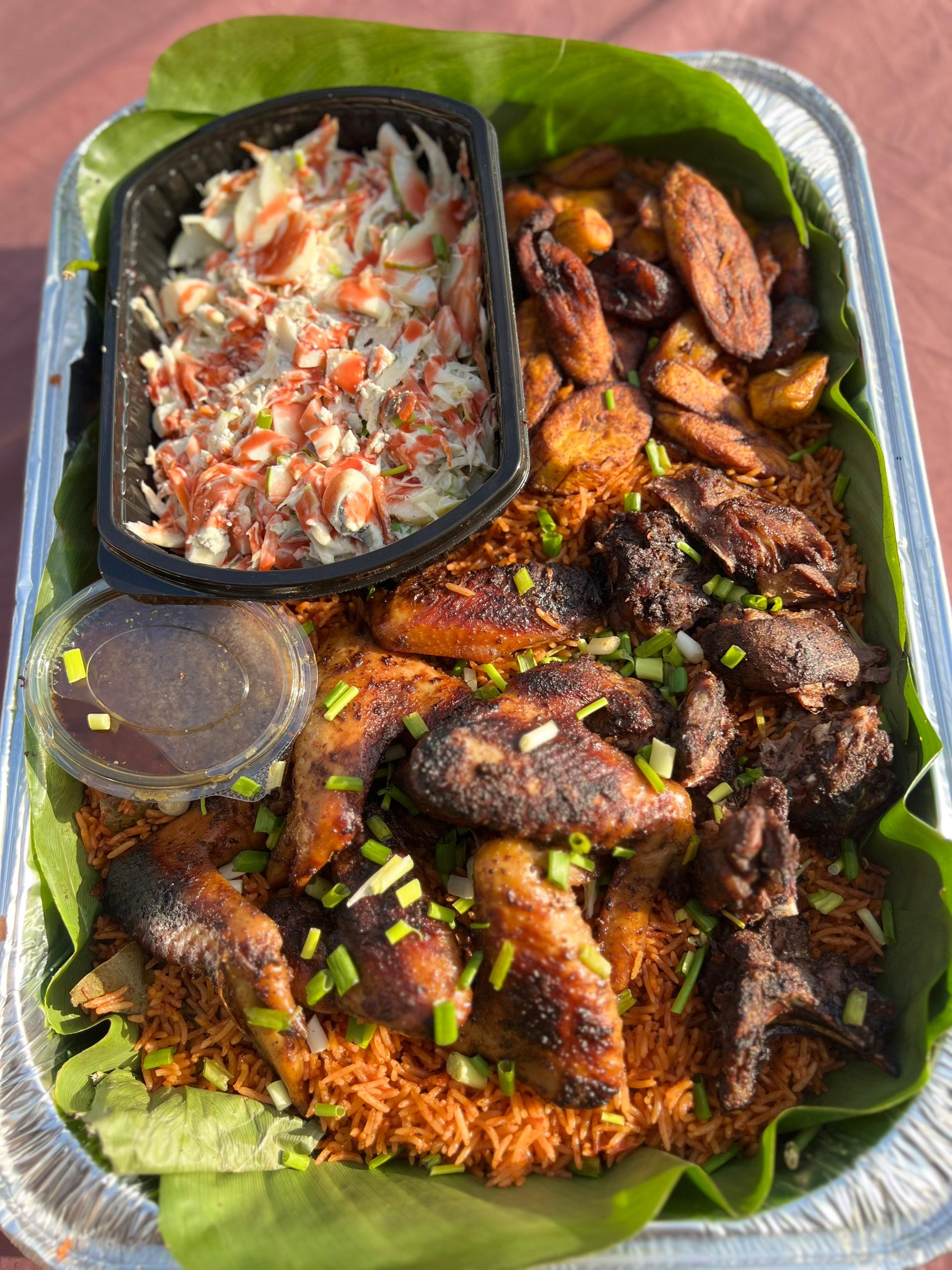 Assortment of Mediterranean dishes including bowls of couscous, topped with fresh herbs, displayed on a wooden table with colorful vegetables and grains.