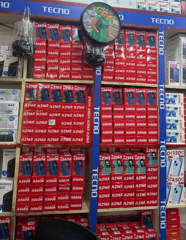 Modern apartment building with vibrant yellow accents, large windows, and balconies, surrounded by palm trees in an urban setting during sunset.
