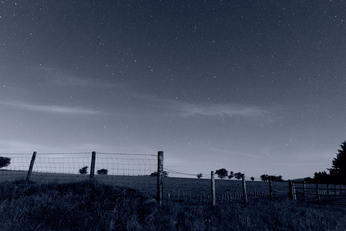 black and white landscape photograph of Welsh countryside by starlight by Mark Lloyd Williams